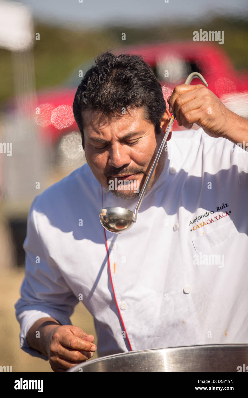 Chef Alejandro Ruiz of Casa Oaxaca prepares a meal during Cook it Raw outdoor BBQ event on Bowen's Island October 26, 2013 in Charleston, SC. Stock Photo