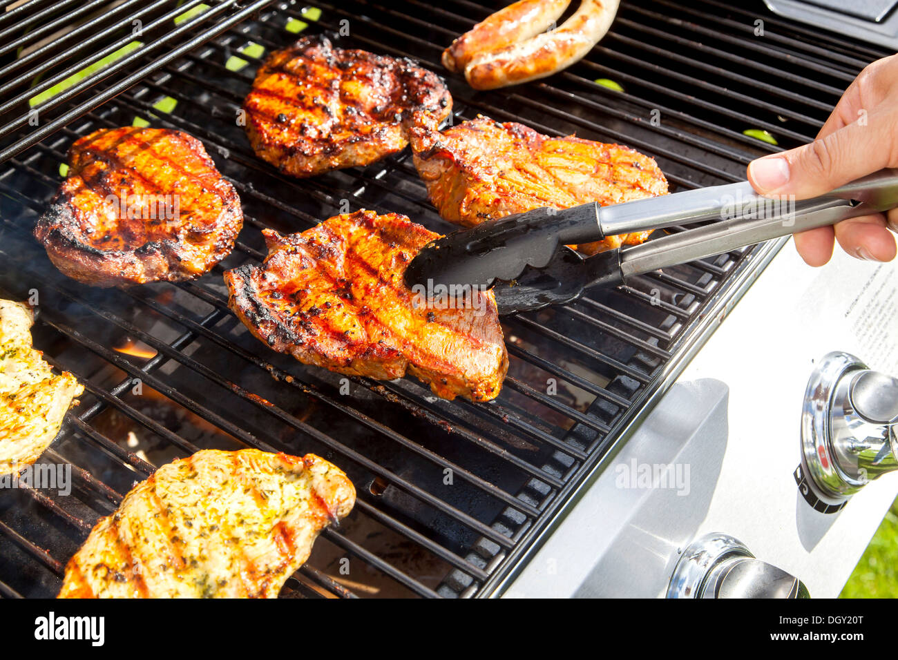 Pork steaks on a gas grill, Germany Stock Photo