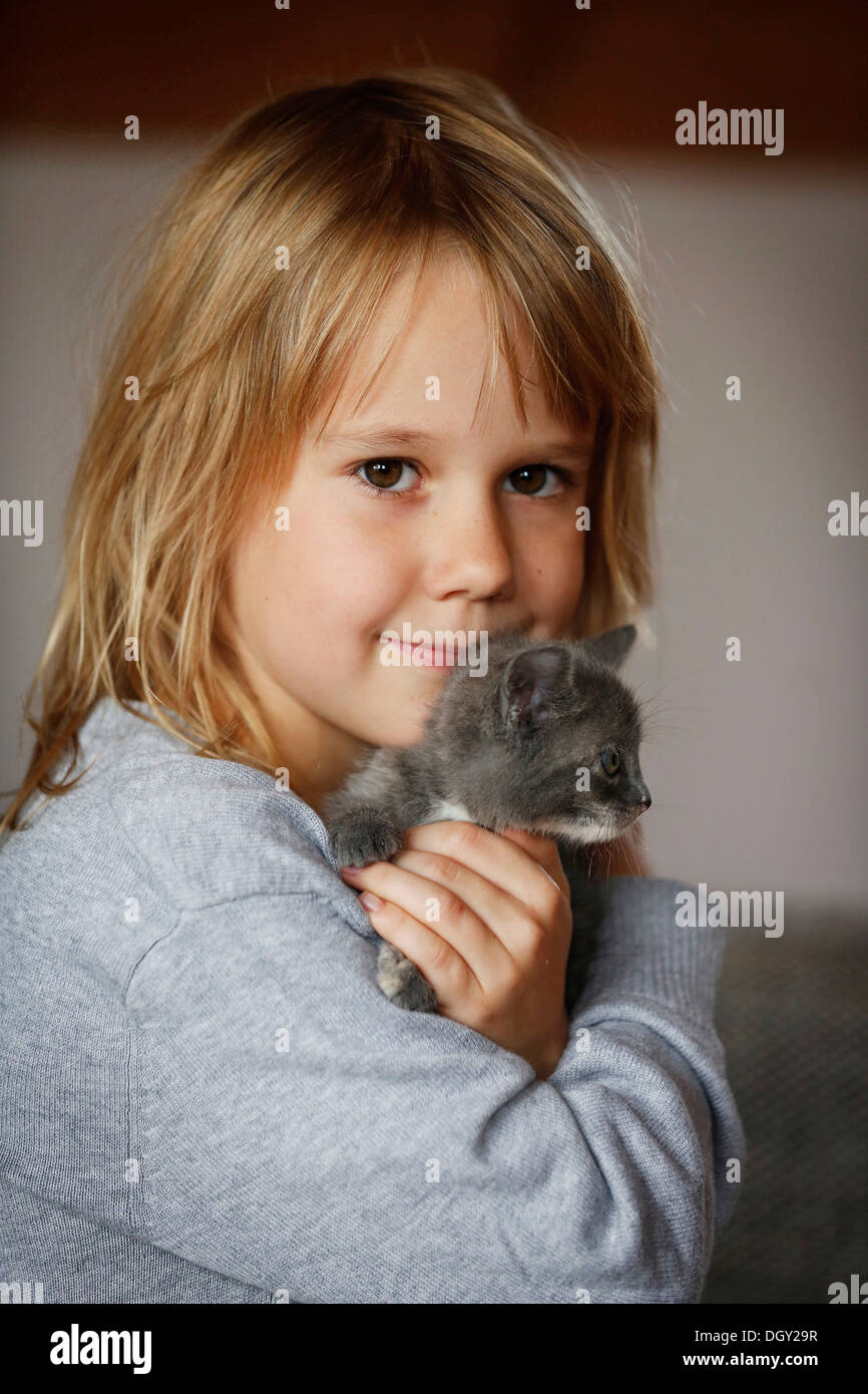 Girl petting a kitten hi-res stock photography and images - Alamy