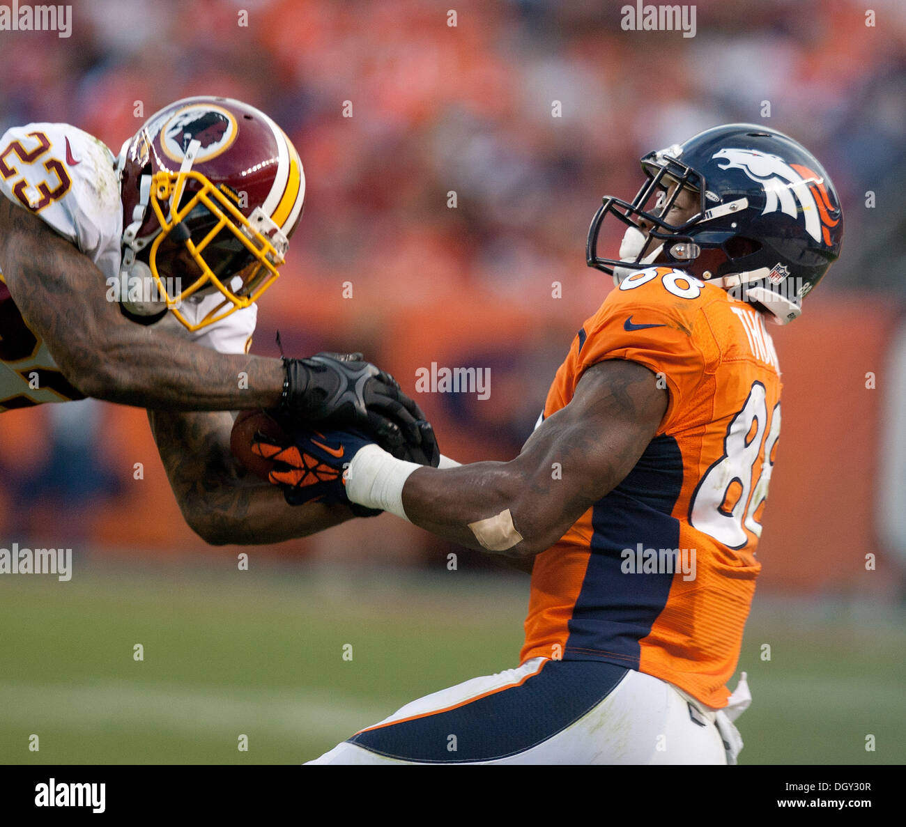Denver, Colorado, USA. 27th Oct, 2013. Denver Broncos WR DEMARYIUS THOMAS, right, battles for the loose ball against the Redskins S DEANGELO HALL, left, during the 4th. quarter at Sports Authority Field at Mile High Sunday afternoon. Broncos beat the Redskins 45-21. © Hector Acevedo/ZUMAPRESS.com/Alamy Live News Stock Photo