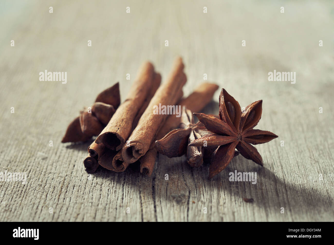 Cinnamon sticks with anis stars closeup on wooden background Stock Photo