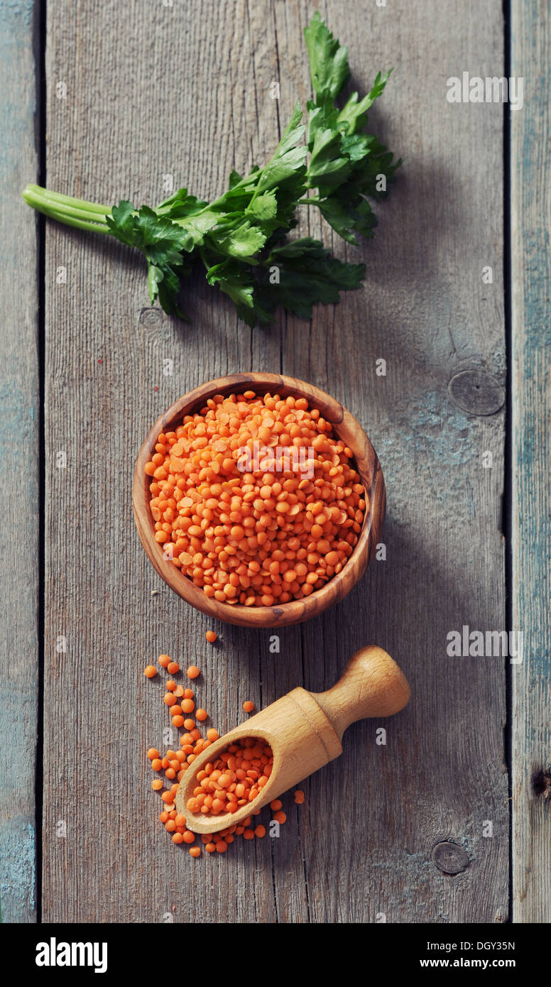 Lentils in wooden bowl with scoop on wooden background  Stock Photo