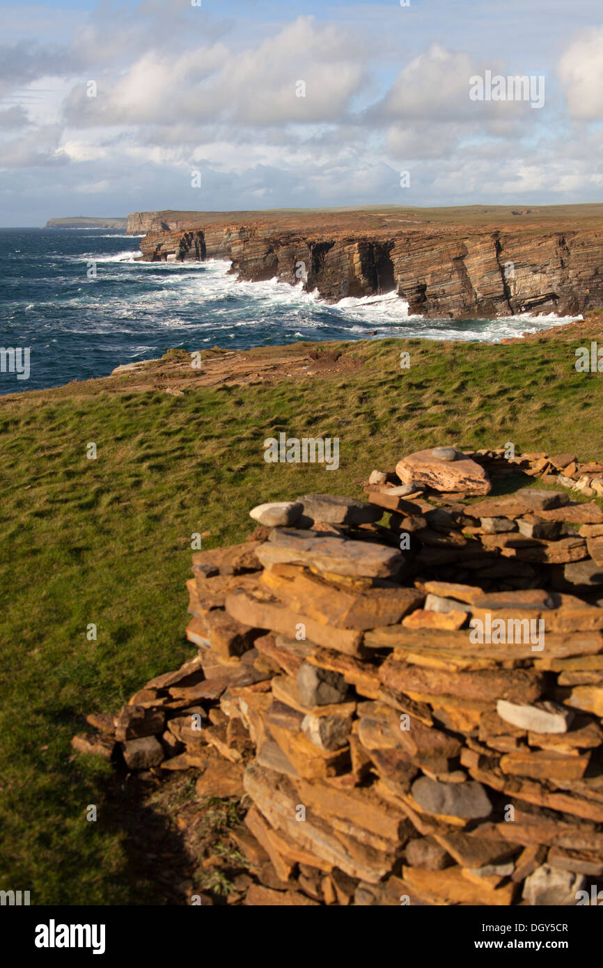 Islands of Orkney, Scotland. Picturesque dramatic view of a cairn at the Brough of Bigging cliffs near Yesnaby. Stock Photo