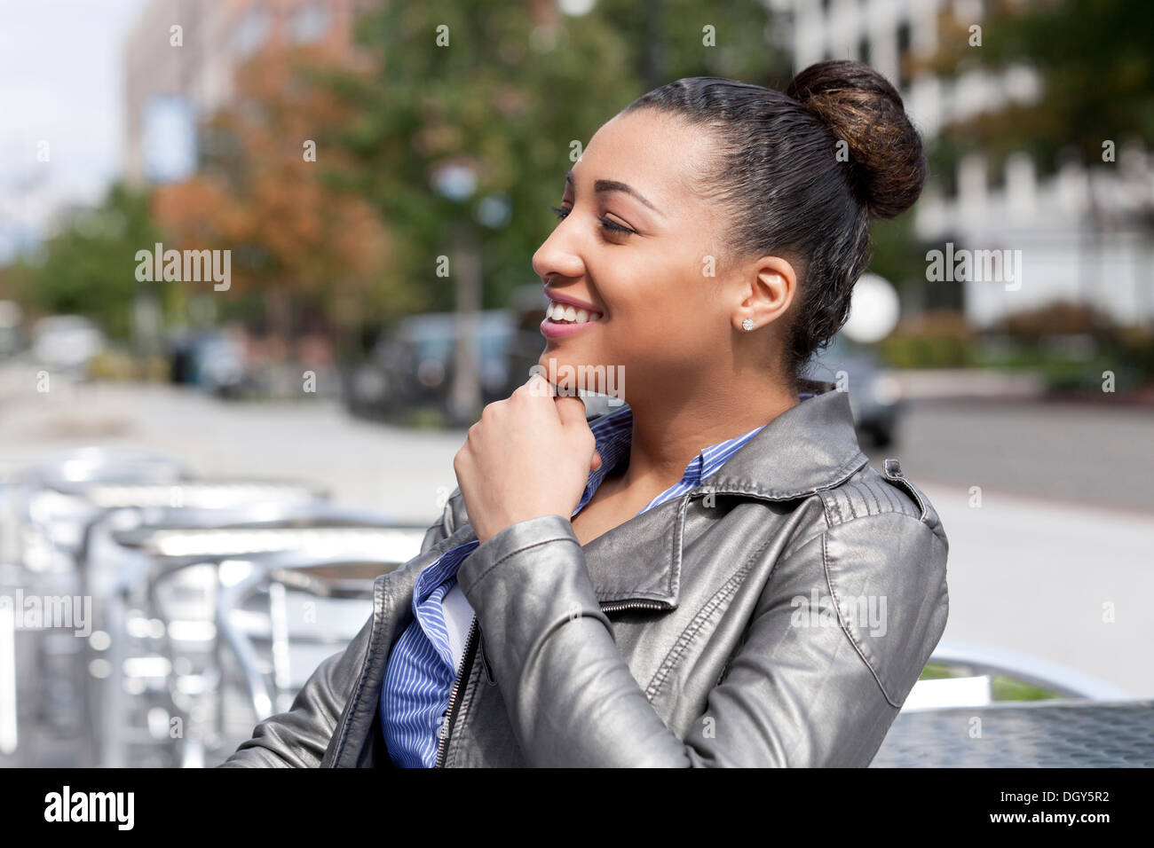 Young African-American woman with hair up in urban environment Stock Photo