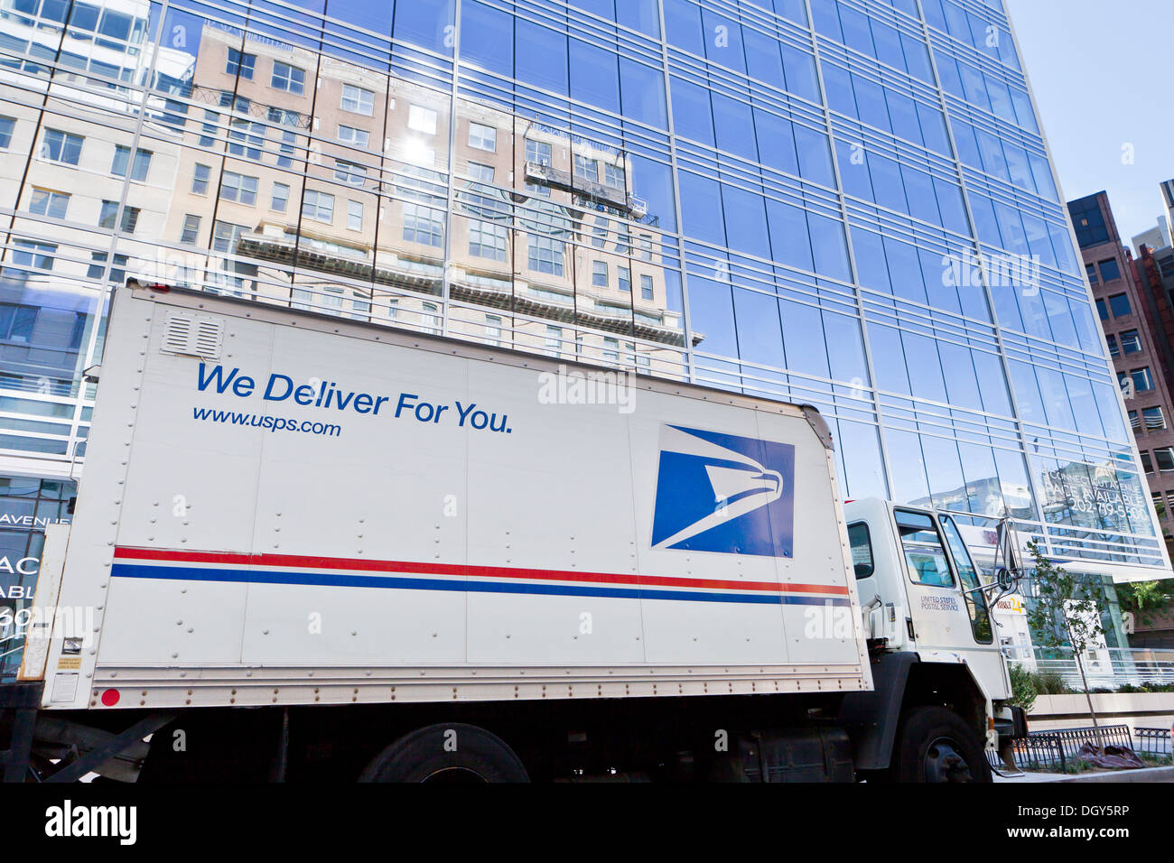 US Postal Service delivery truck in front of office building