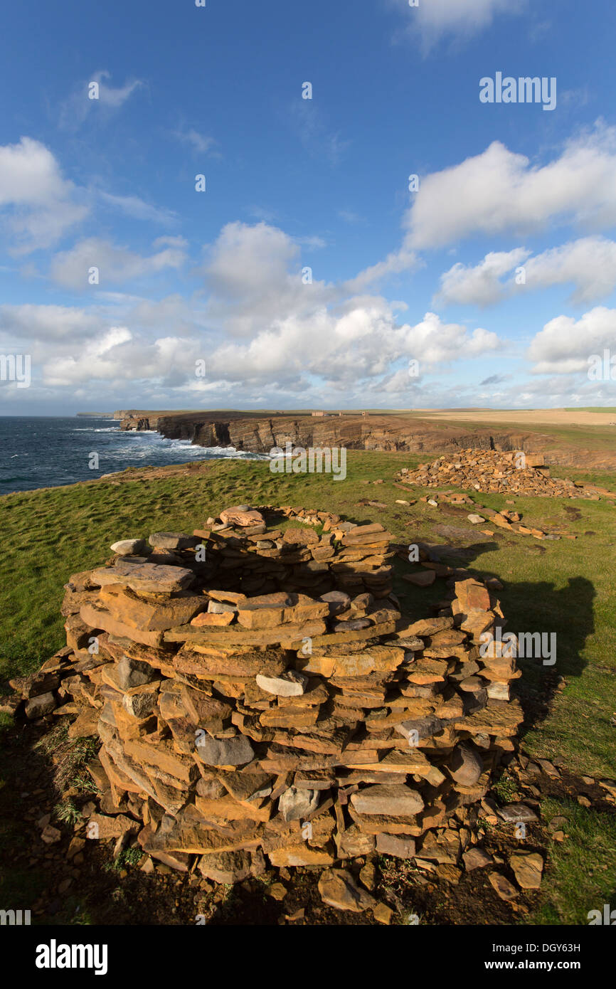 Islands of Orkney, Scotland. Picturesque dramatic view of a cairn at the Brough of Bigging cliffs near Yesnaby. Stock Photo