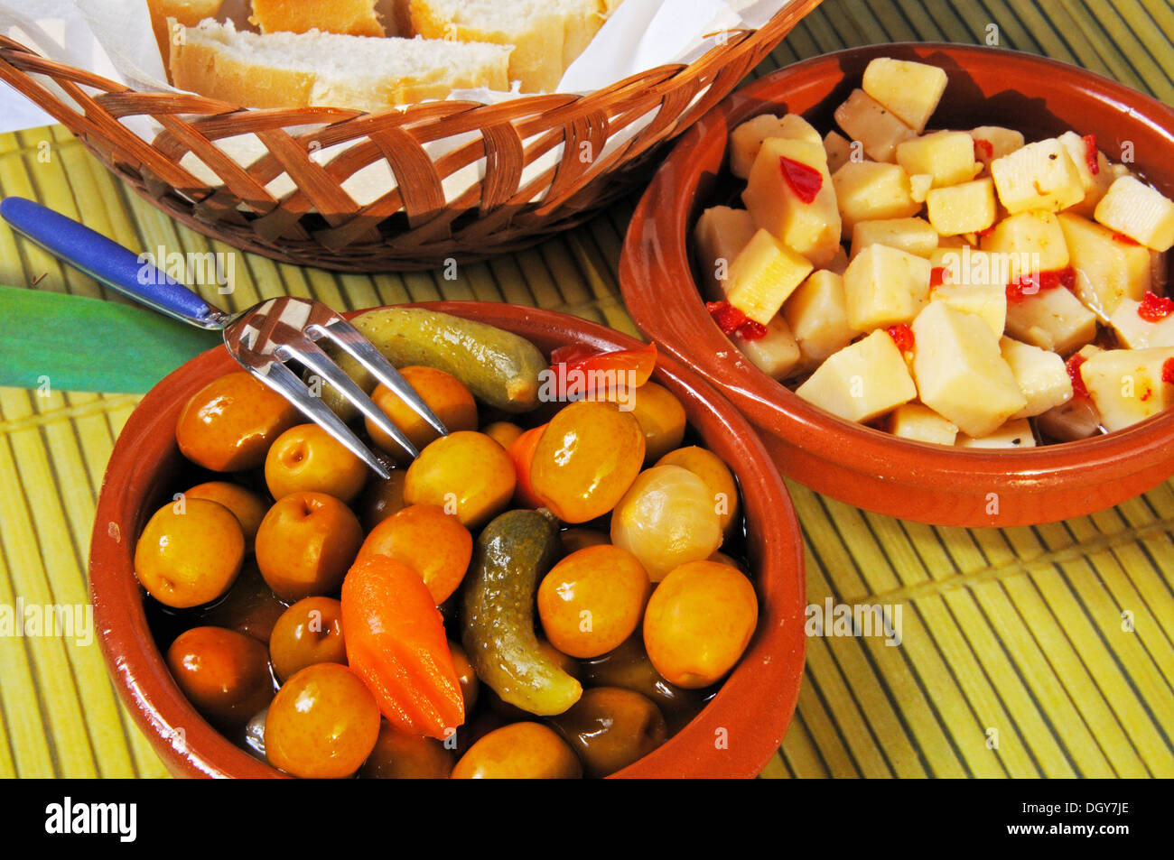 Spanish tapas of Green olive salad, bread and Manchego cheese with ...