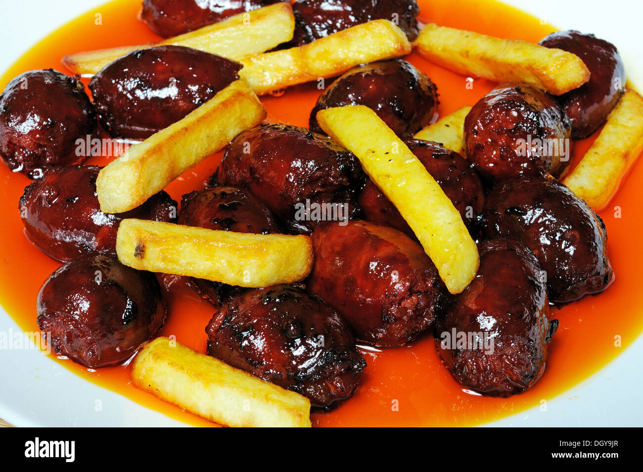 Mini chorizo sausages and chipped potatoes in olive oil tapas, Costa