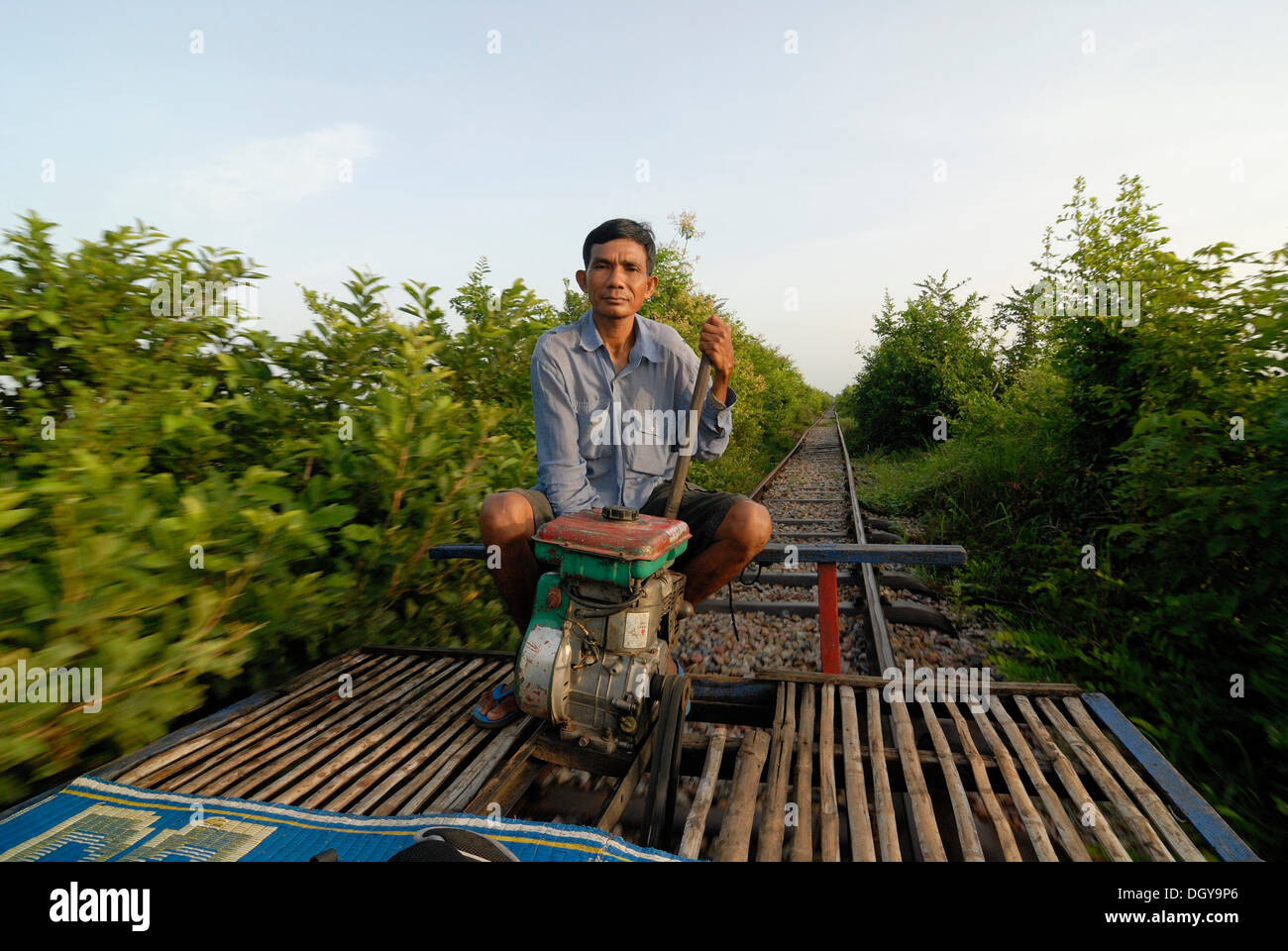 54 year old Khmer man, Cambodian, traveling along the disused railway line of Battambang-Phnom Penh with his home-built bamboo Stock Photo