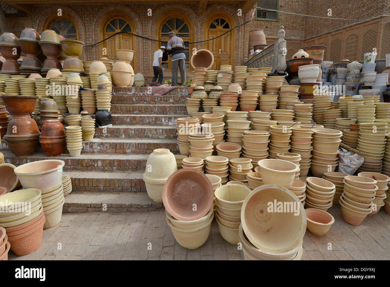 Kashgar crafts, Muslim Uighurs are offering their pottery and ceramics in front of an Uighur mud-brick house on the Kashgar Stock Photo