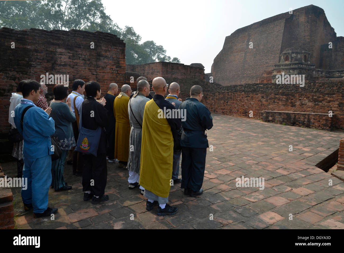 Japanese pilgrims praying at an archaeological site, important Buddhist pilgrimage destination, ruins of the ancient University Stock Photo