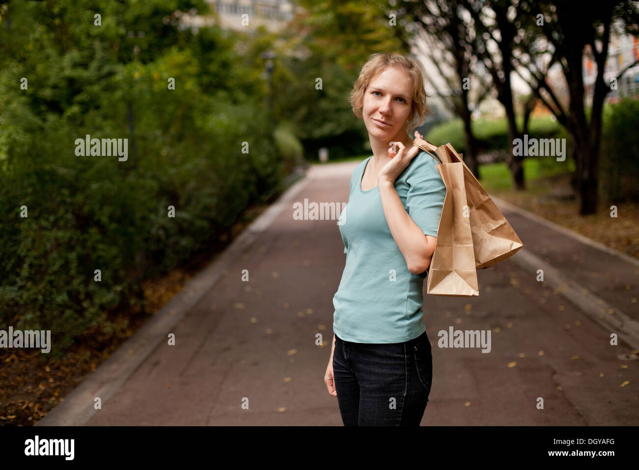 young smiling woman holding shopping bags Stock Photo