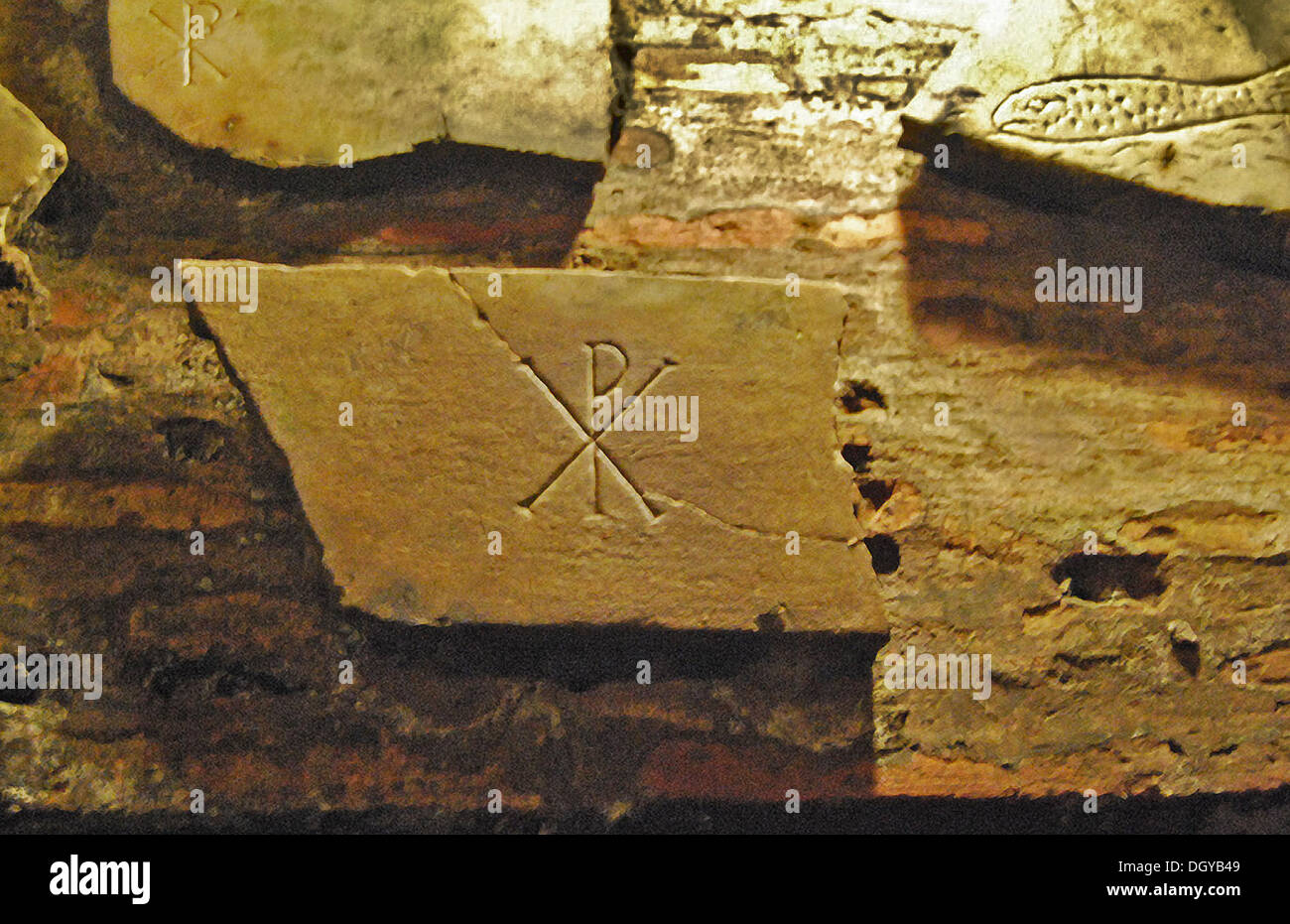 5538. Catacomb of San Callisto in Rome. Early Christian symbols, the fish and the ‘Chi Roh’ an anagram for “Jesus Christ Savior the Son of God” Stock Photo