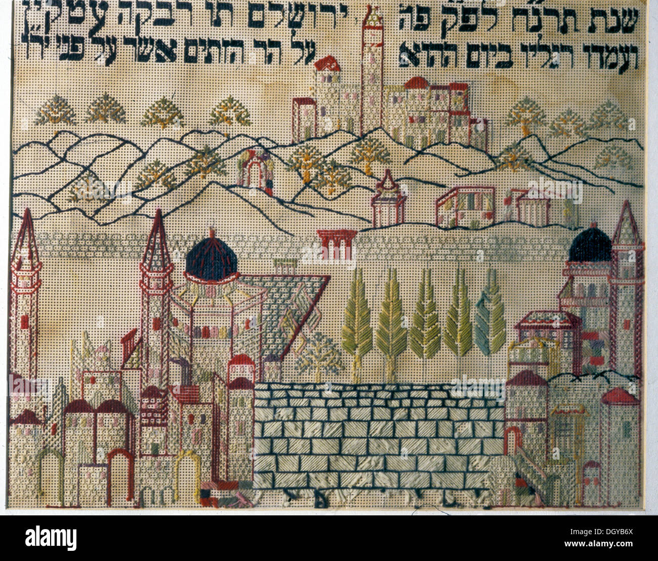 5585. Embroidery called 'East' - stitch sampler hanging on the eastern wall of the mid European Jewish house to indicate the direction of prayer to Jerusalem, western wall in the center. Stock Photo