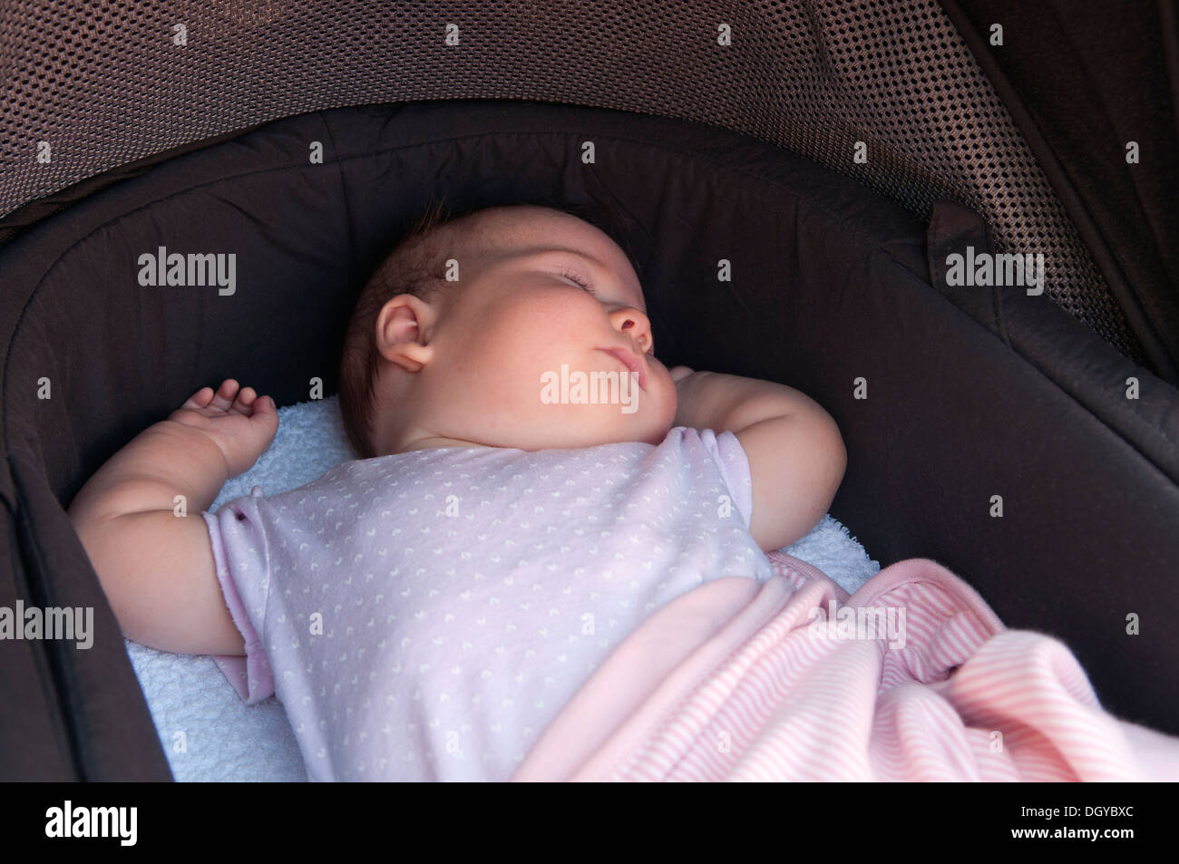Little baby girl asleep in her pram outside Stock Photo Alamy