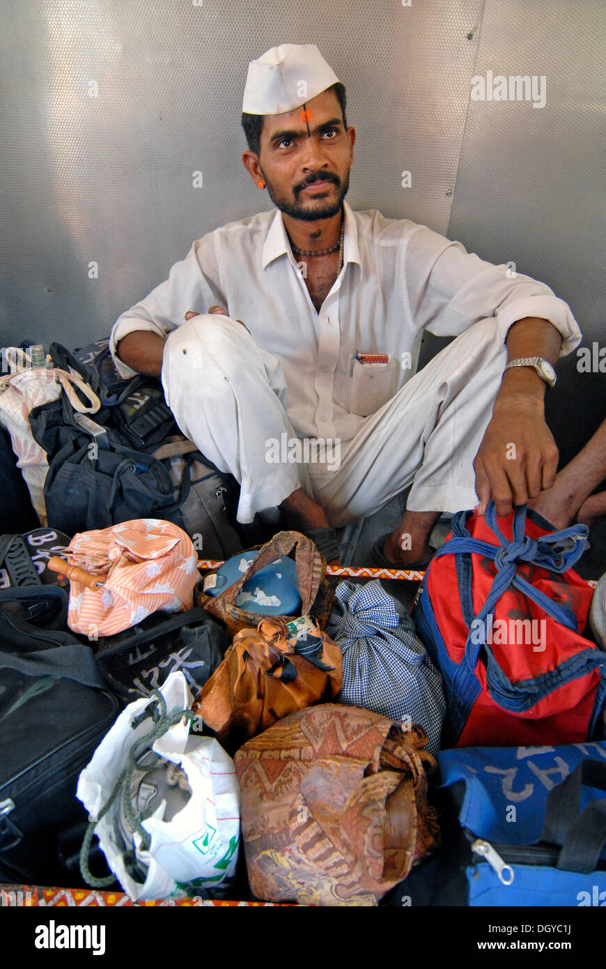 Dabba wallah or food deliverer with Dabbas or food containers in a local train, Mumbai, India, Asia Stock Photo