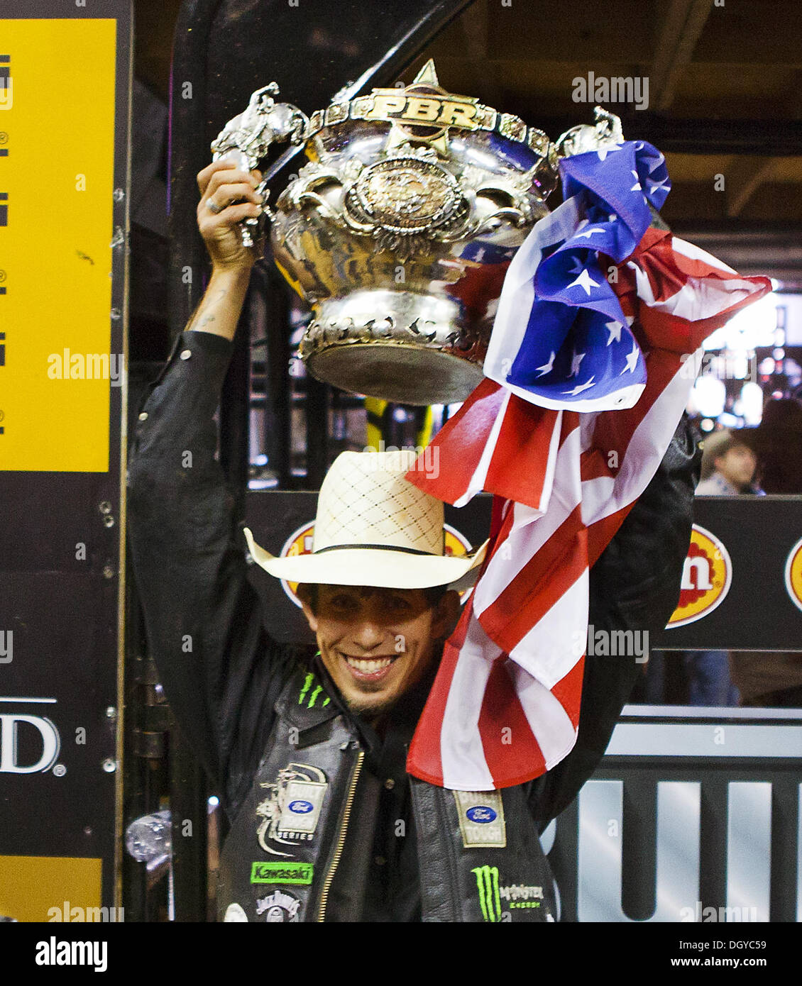 Las Vegas, Nevada, USA. 27th Oct, 2013. J.B. MAUNEY hoists the winning trophy following the 2013 PBR Built Ford Tough World Finals at the Thomas & Mack Center on Sunday. © L.E. Baskow/L.E. Baskow/ZUMAPRESS.com/Alamy Live News Stock Photo