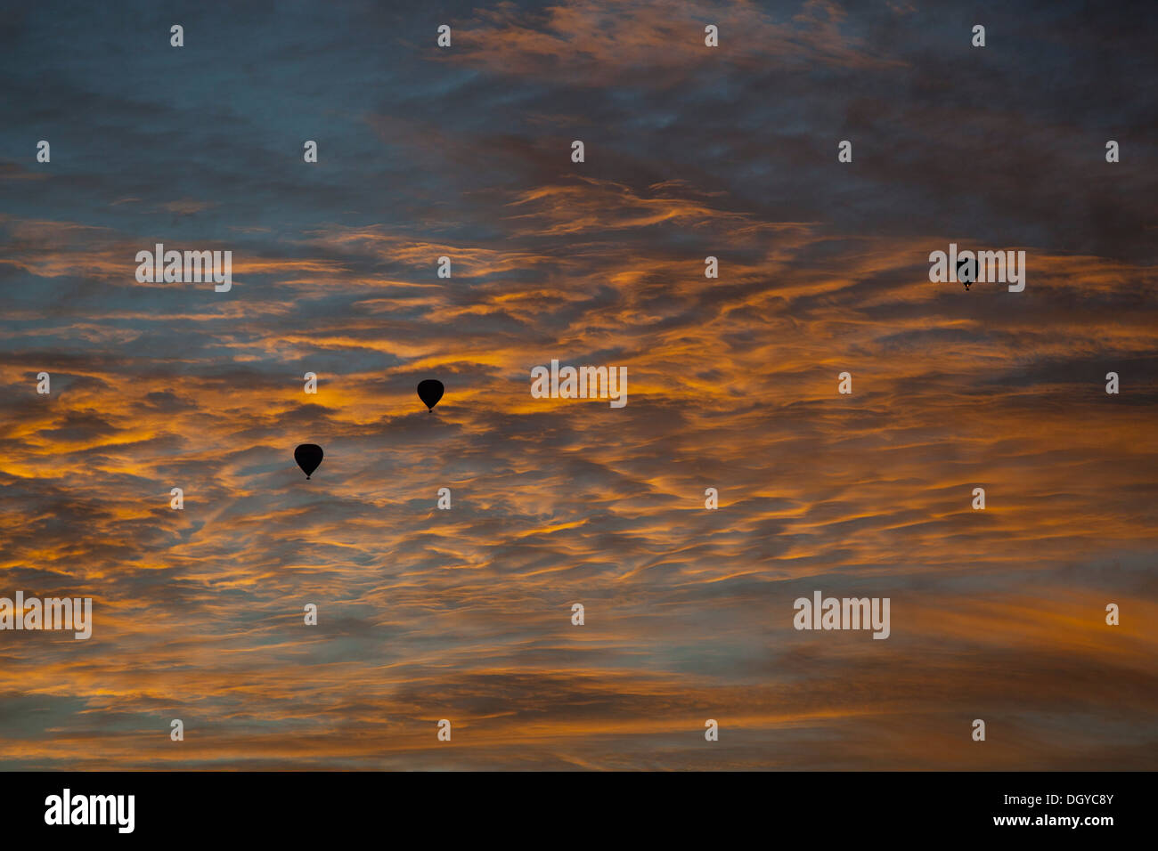 Three silhouetted hot air balloons against a dusk sky in Melbourne, Victoria, Australia Stock Photo