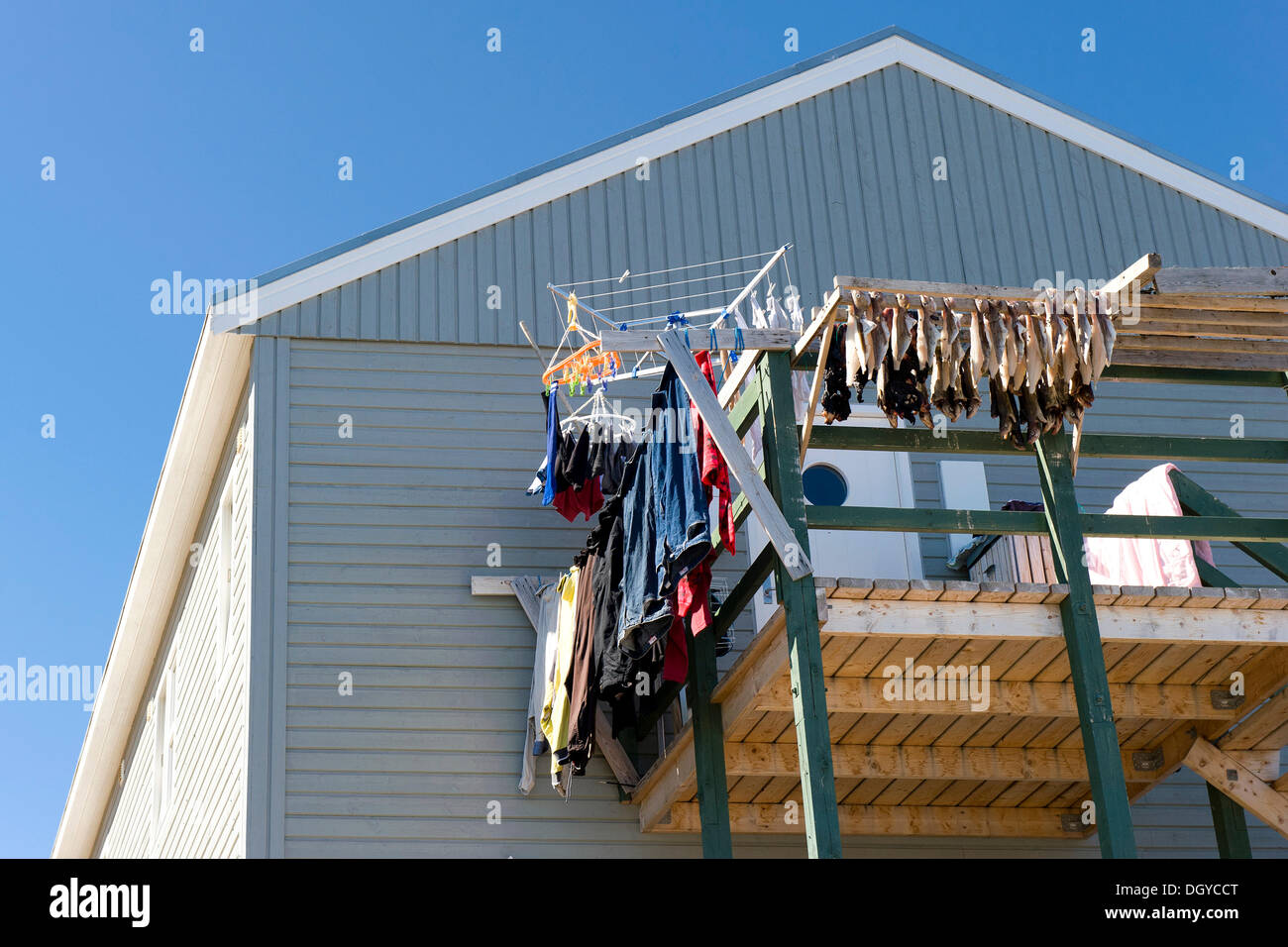 Dried fish and laundry on a balcony, Tasiilaq or Ammassalik, East Greenland, Greenland Stock Photo