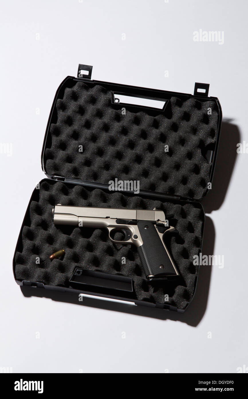 A handgun in a protected briefcase with a bullet Stock Photo