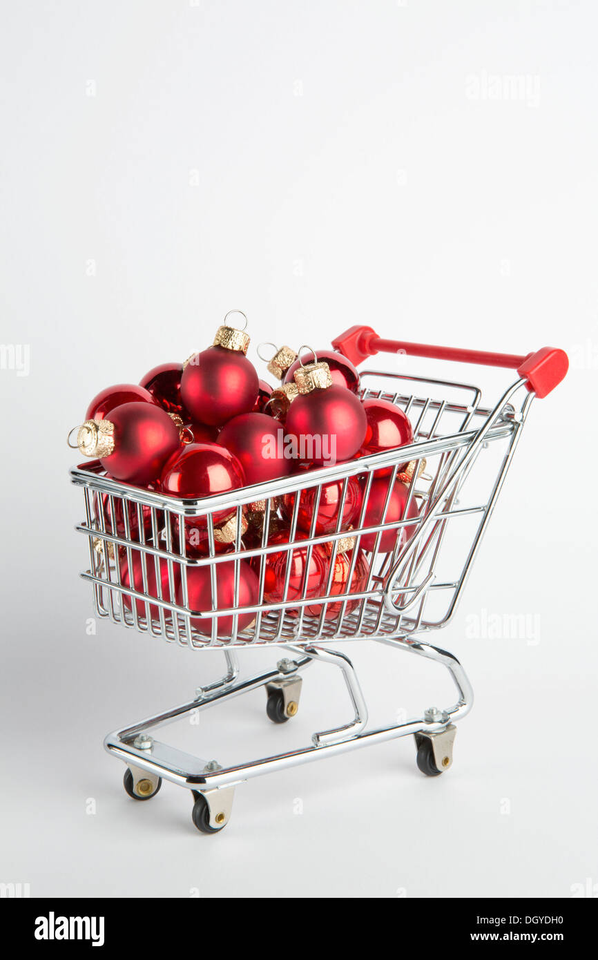 A shopping cart full of red ball holiday ornaments Stock Photo
