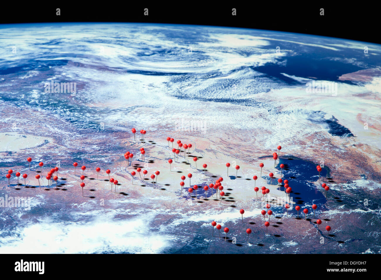 A satellite view of Earth with straight pins at various locations, digital composite Stock Photo