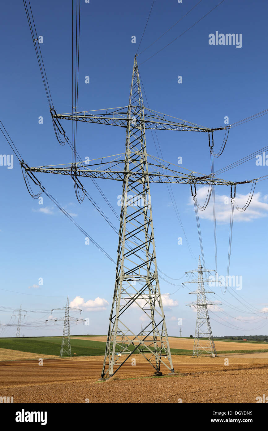 Electricity pylons and lines on a field, power and energy topic Stock ...