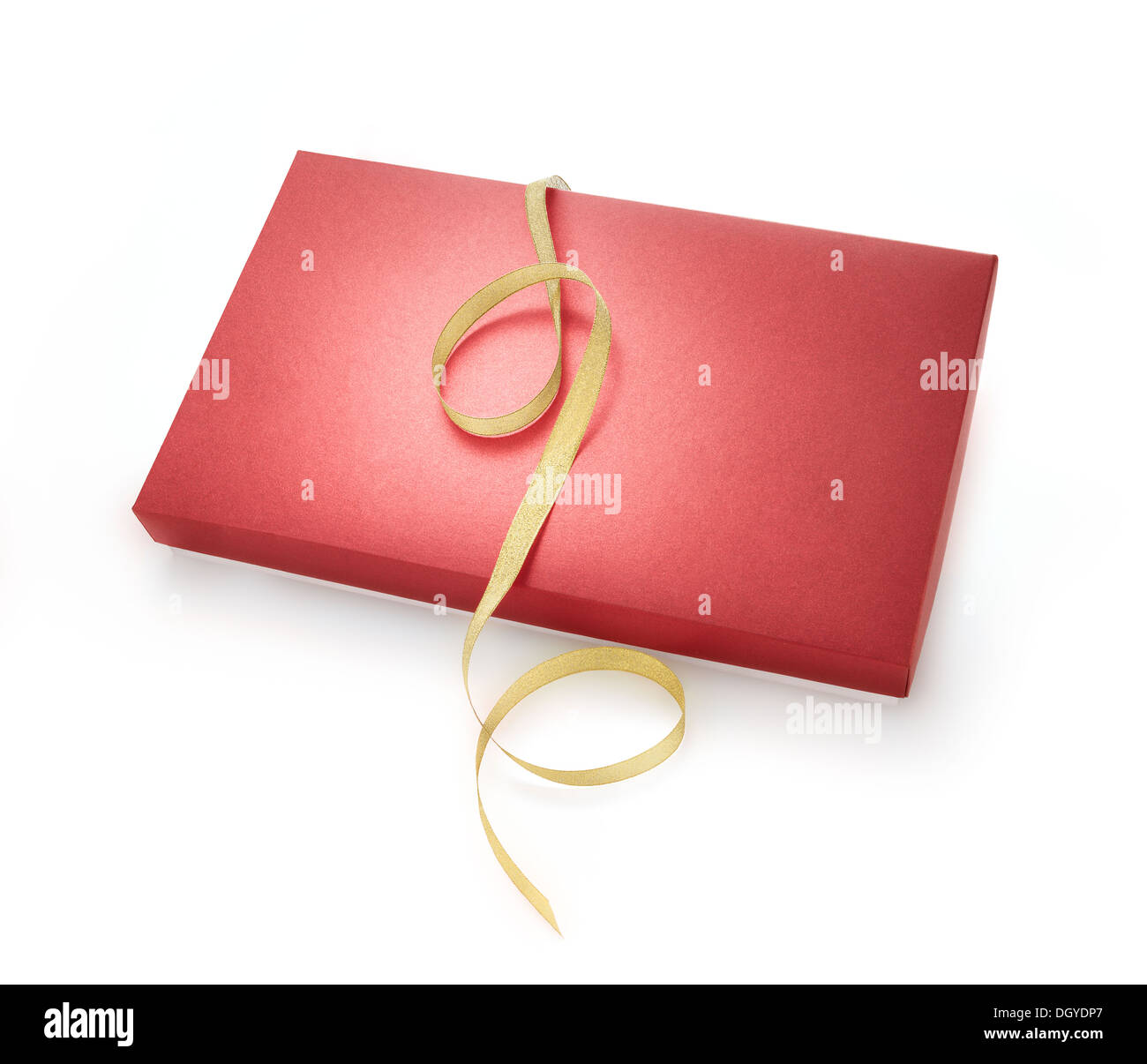 Red box with golden ribbon on white background. Stock Photo