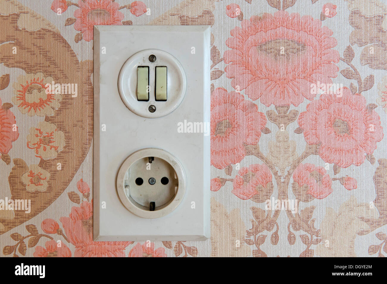 Old socket and light switch, wallpaper from the sixties, Stuttgart, Baden-Wuerttemberg Stock Photo