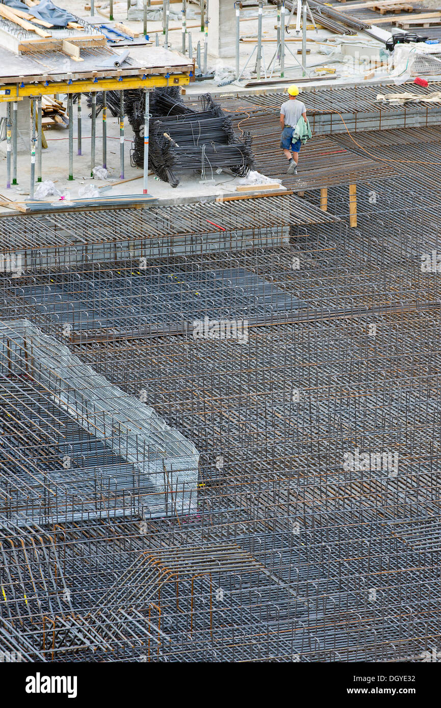 Construction workers, reinforcing steel, large construction site