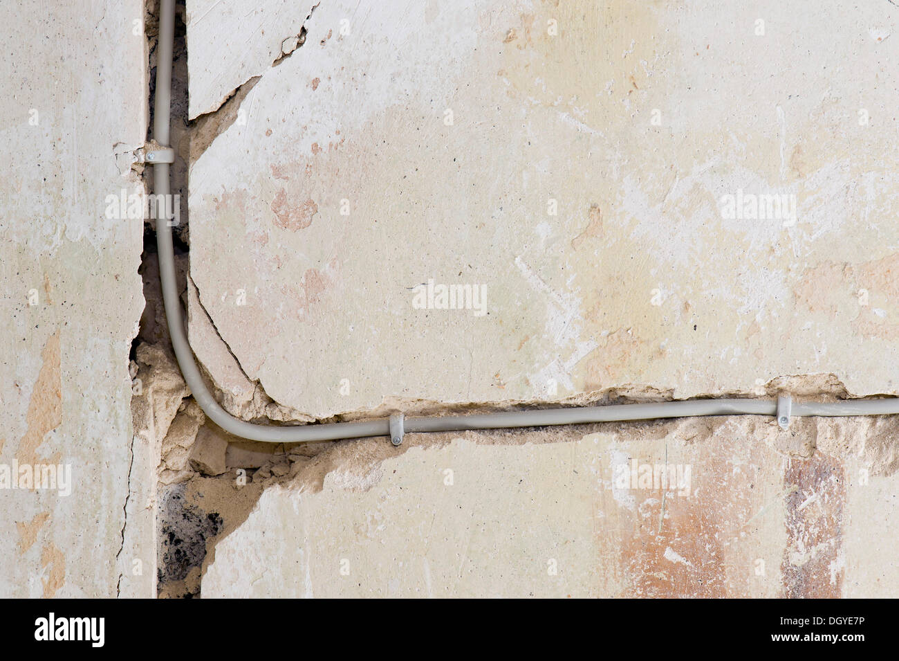 Electric cable laid under plaster in a cable canal in an old building