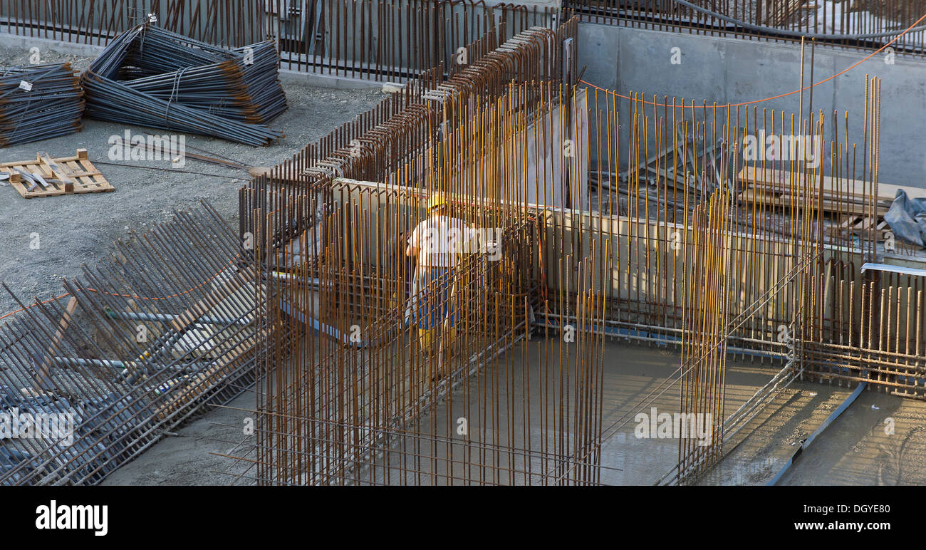 Construction workers, reinforcing steel, large construction site
