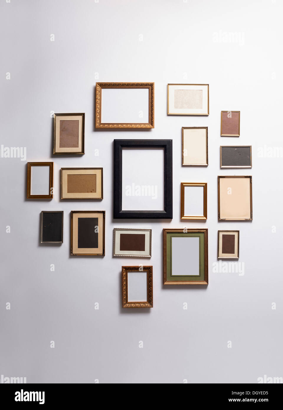 Various empty picture frames hanging on a wall Stock Photo