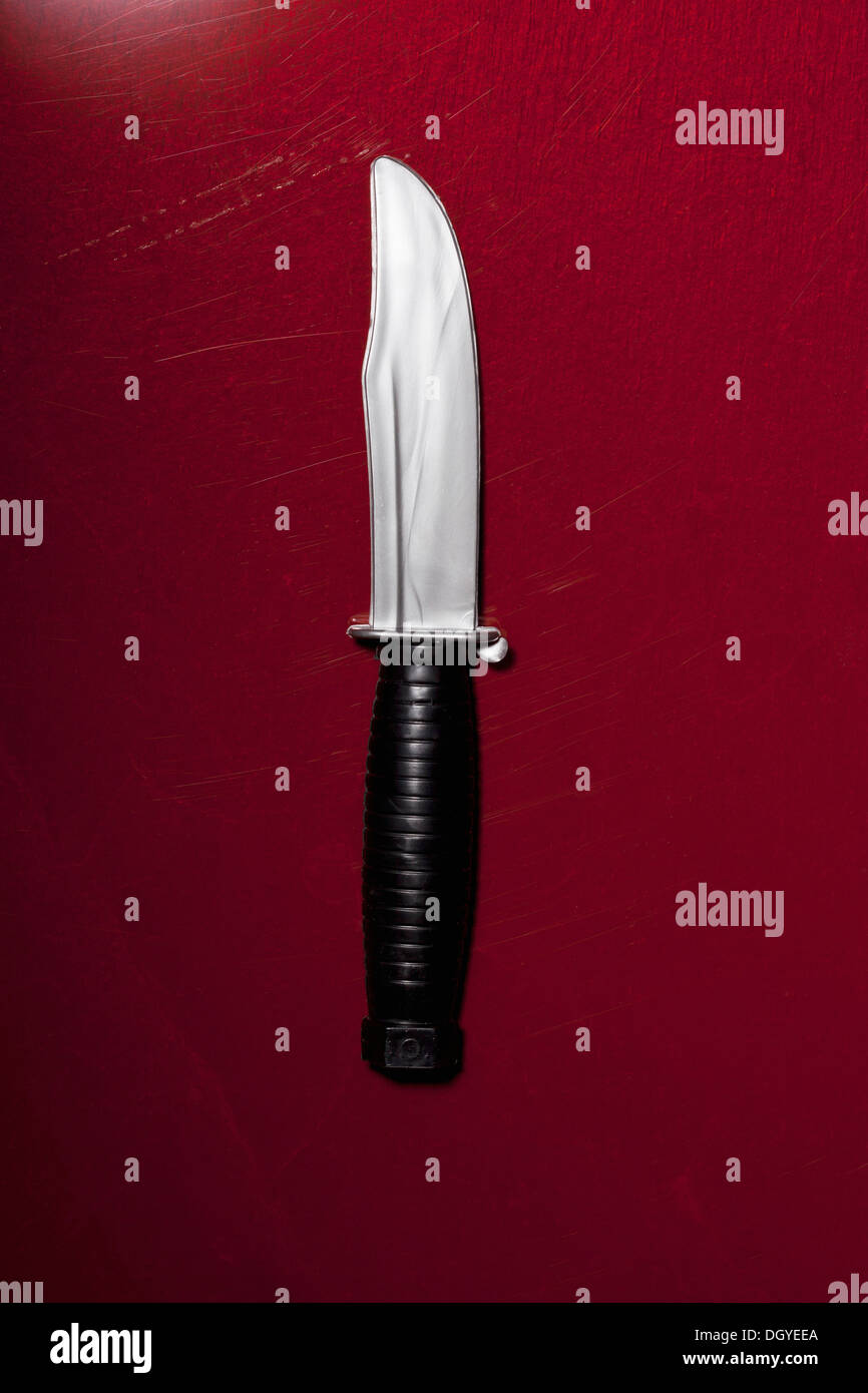 A hunting knife on a red background Stock Photo