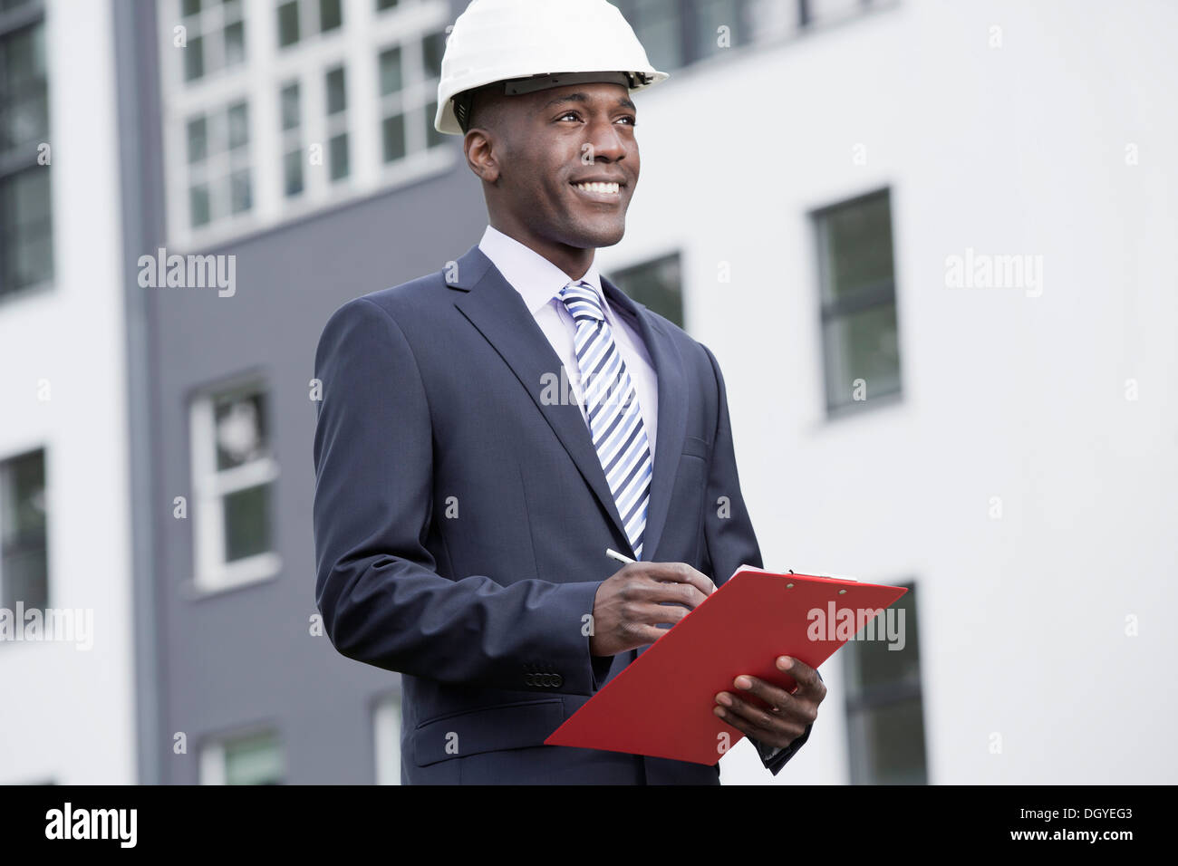 Businessman happily overseeing his work Stock Photo