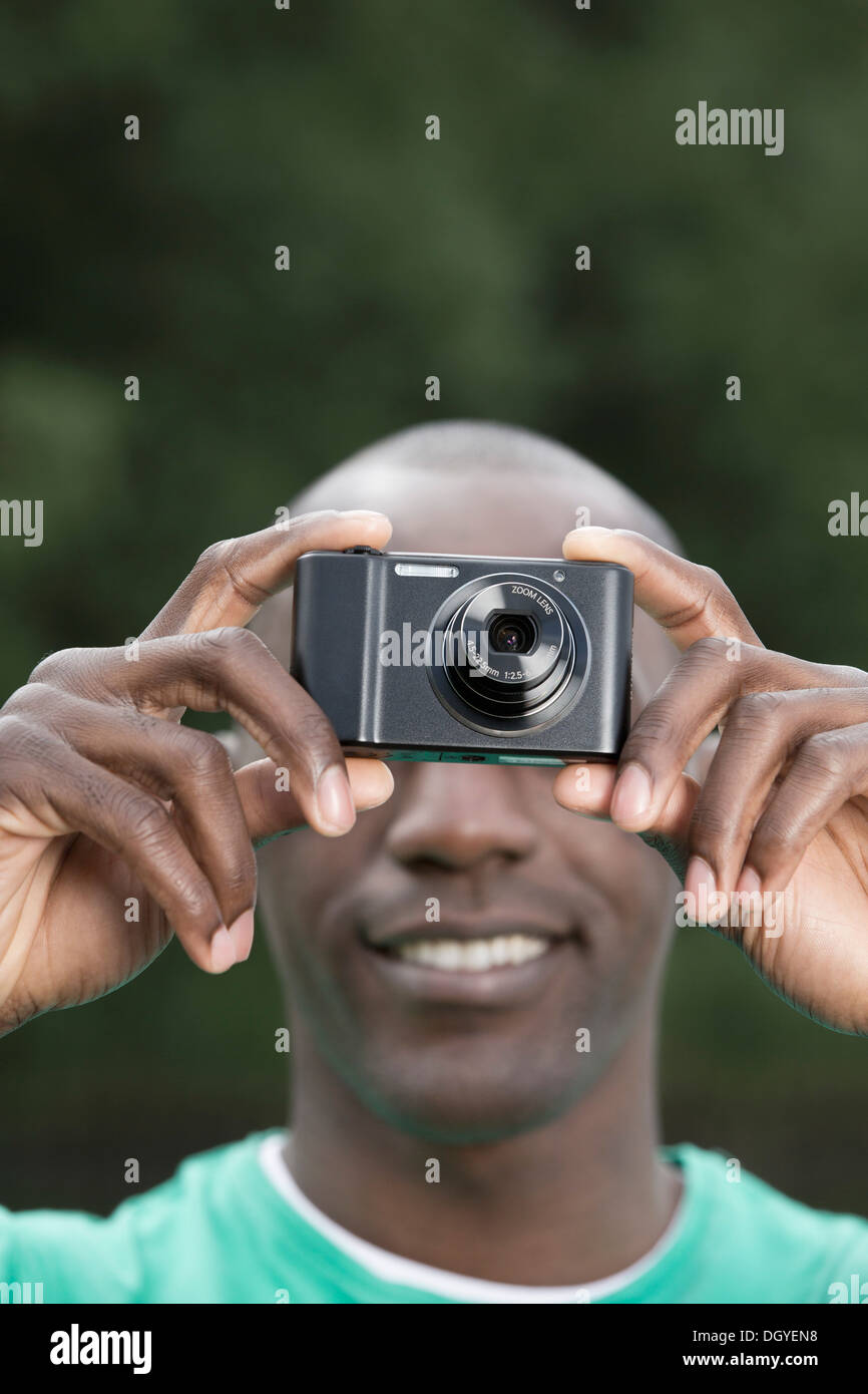 Man taking photograph with digital camera Stock Photo