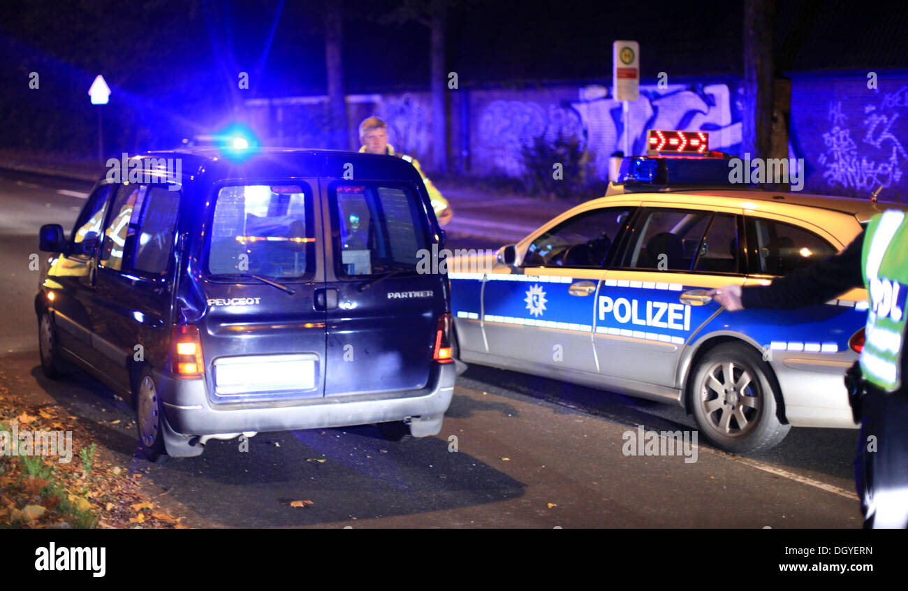 Bremen, Germany. 27th Oct, 2013Policecars stands next to a car, in which a stealn ATM is kept in Bremen, Germany, 27 October 2013. Thieves attempted to steal the ATM from a steel plant in Bremen, driving a car into the building, tearing the ATM from its anchor and loading it into their vehicle. Police stopped  the vehicle, but the perpetrators were able to flee on foot. Photo: FLORIAN KATER/dpa/Alamy Live News Stock Photo