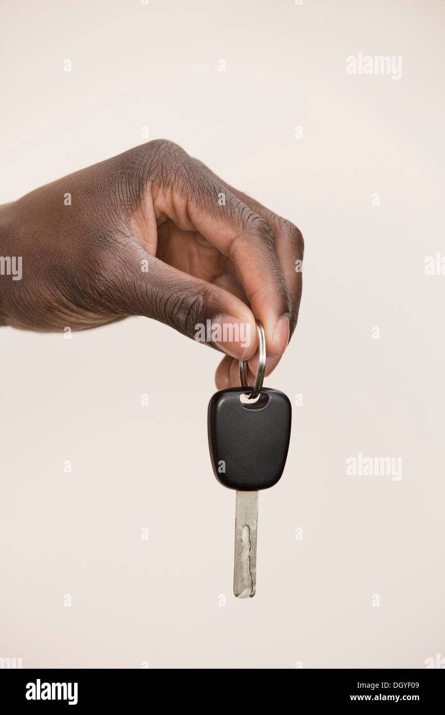 Studio shot of man holding car key Stock Photo