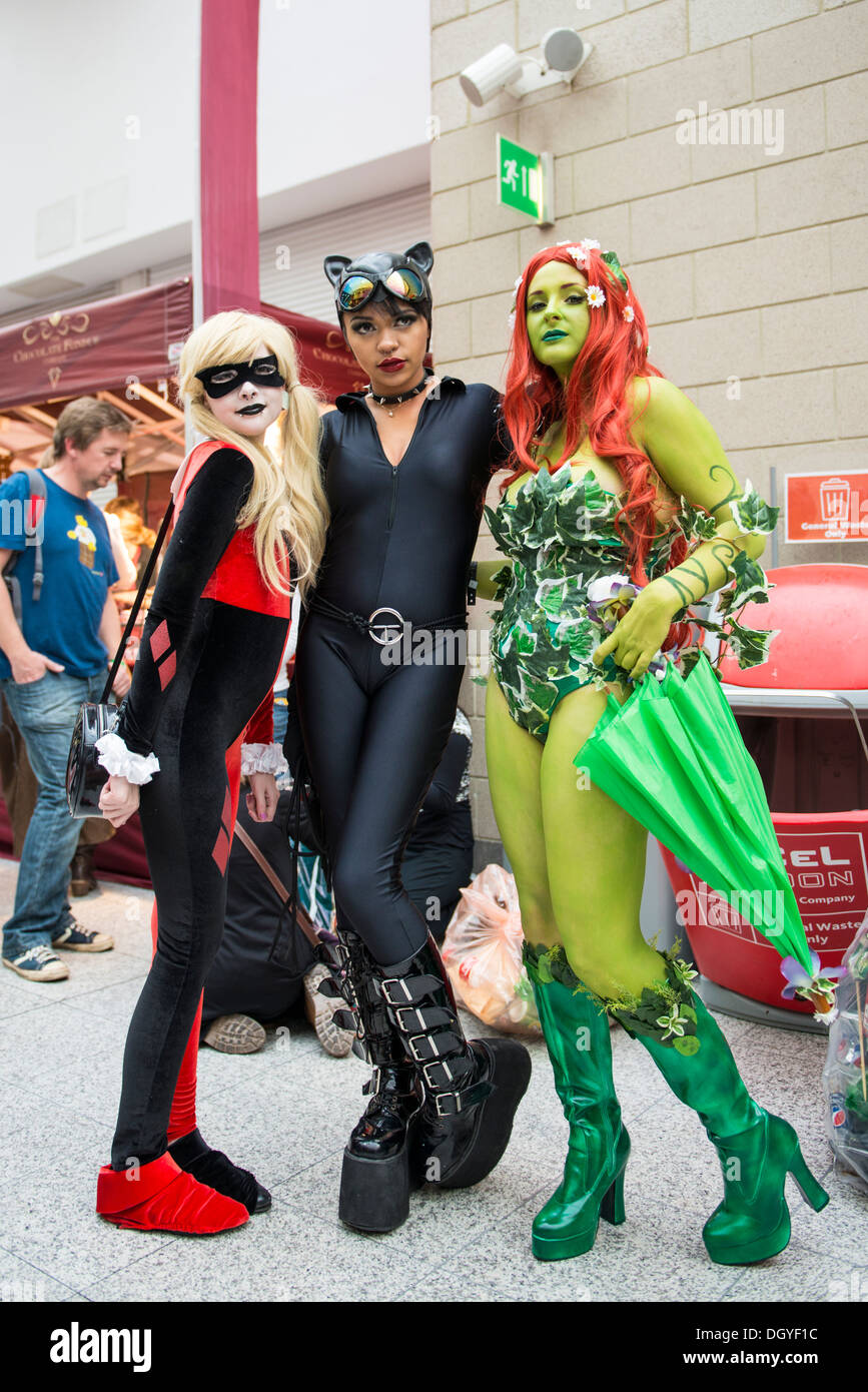 LONDON, UK - OCTOBER 26: Cosplayers dressed as a Harley Quinn, Catwoman and Poison Ivy from Batman for the Comicon. Stock Photo