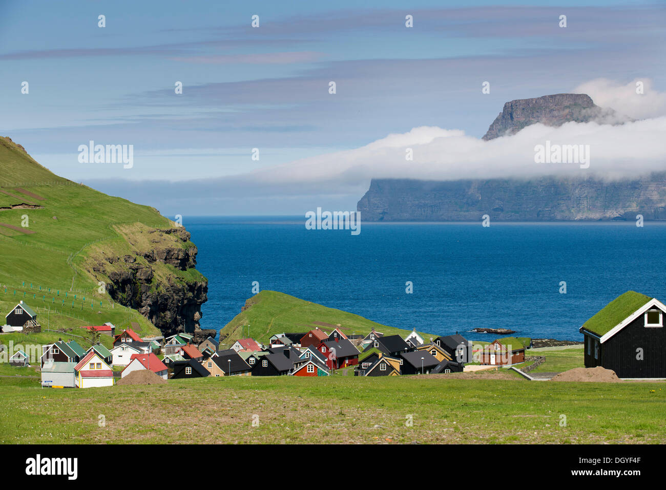 Village with typical colourful houses, Kalsoy island at back, Gjogv, Eysturoy, Faroe Islands, Denmark Stock Photo