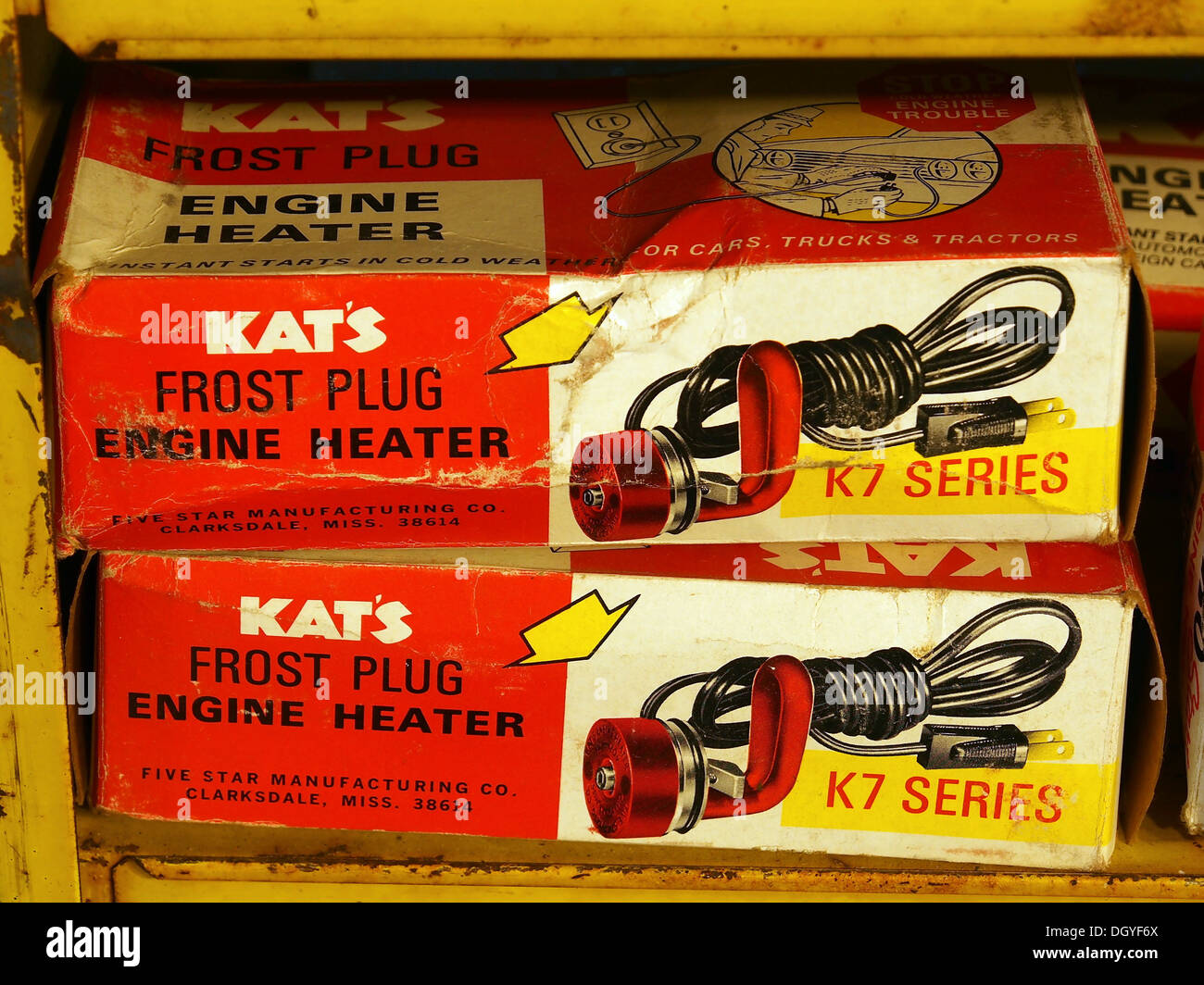 The Kat's frost plug engine heater, displayed with old tins and toys