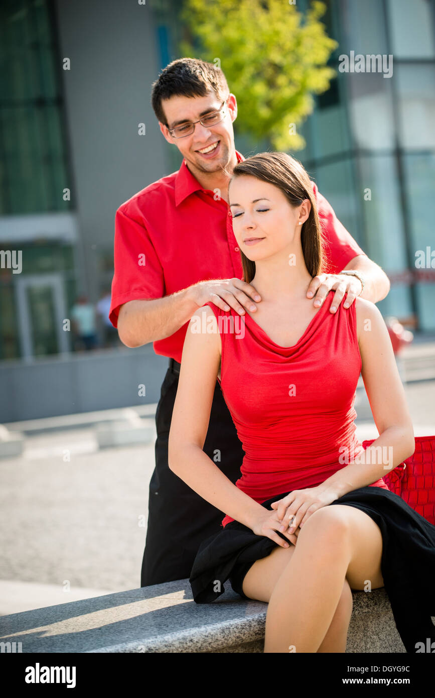 Man giving woman a shoulder massage Stock Photo