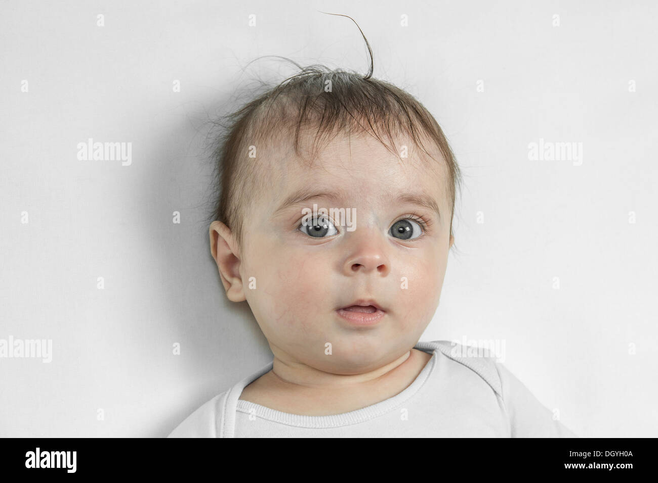 A baby boy looking contemplative, close-up Stock Photo