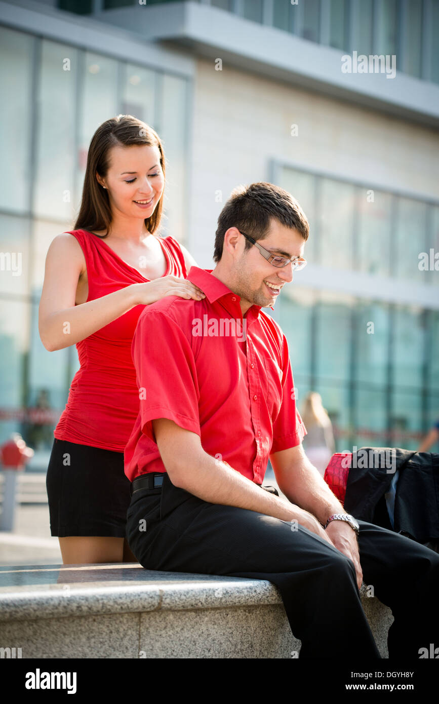 A woman giving a man shoulder massage Stock Photo - Alamy