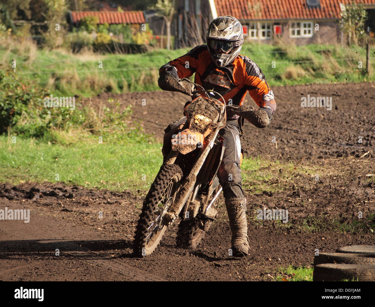 Enduro rallye offroad motorcycle rider cornering in typical fashion with inside leg out. Ruurlo, Gelderland, the Netherlands Stock Photo
