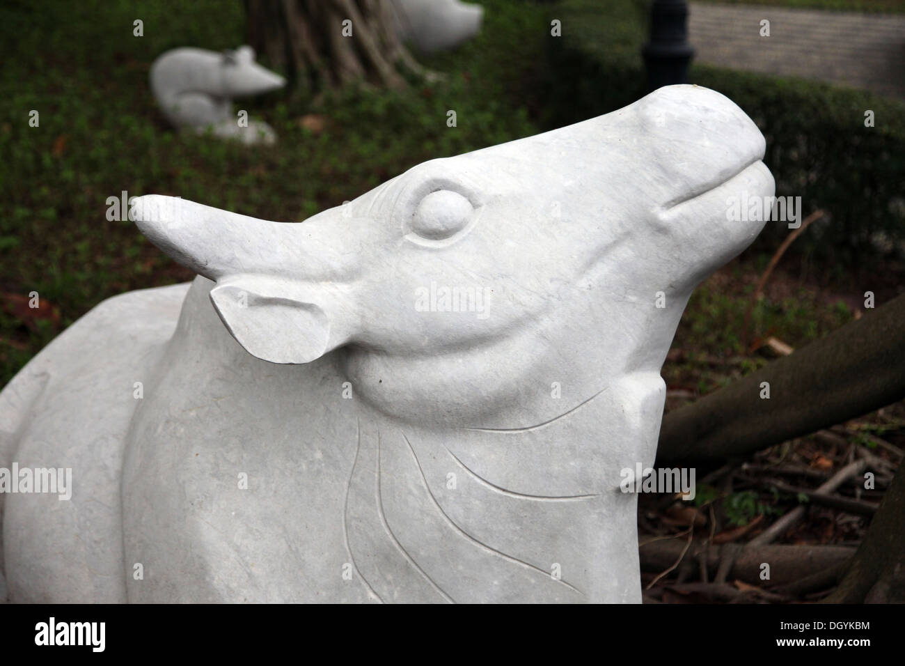 It's a photo of a statue in Paster or white material that is representing a Chinese zodiacal animal: Rabbit Dragon Ox dog cow Stock Photo