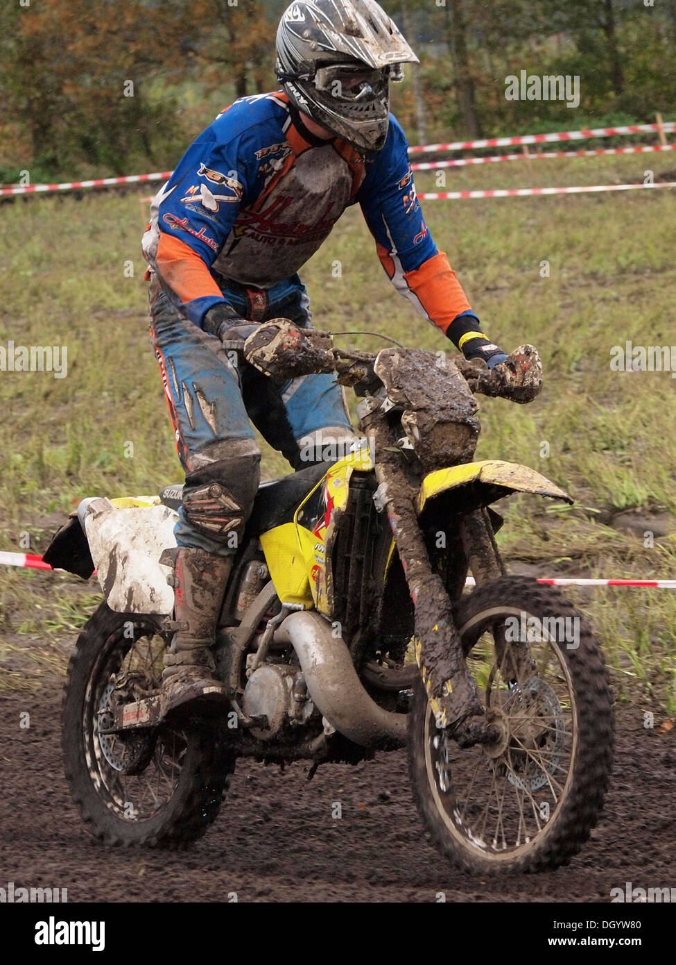 off road motorcyclist standing on footpegs of this two-stroke cross motorcycle Stock Photo