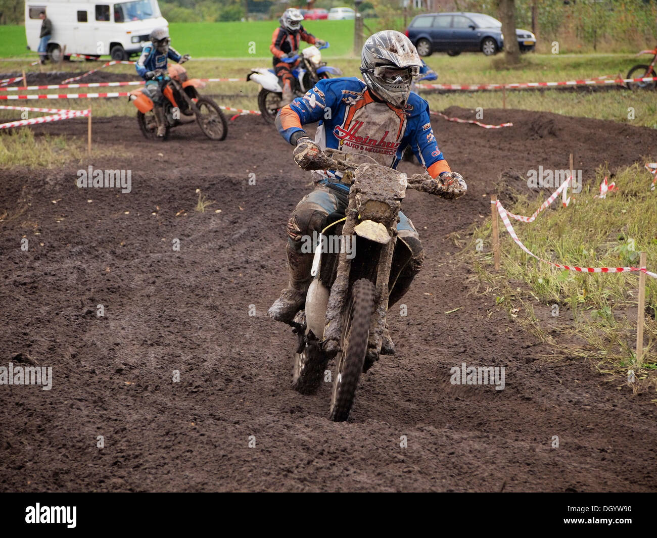 Group of recreational enduro riders on a dirt track part of the course ...