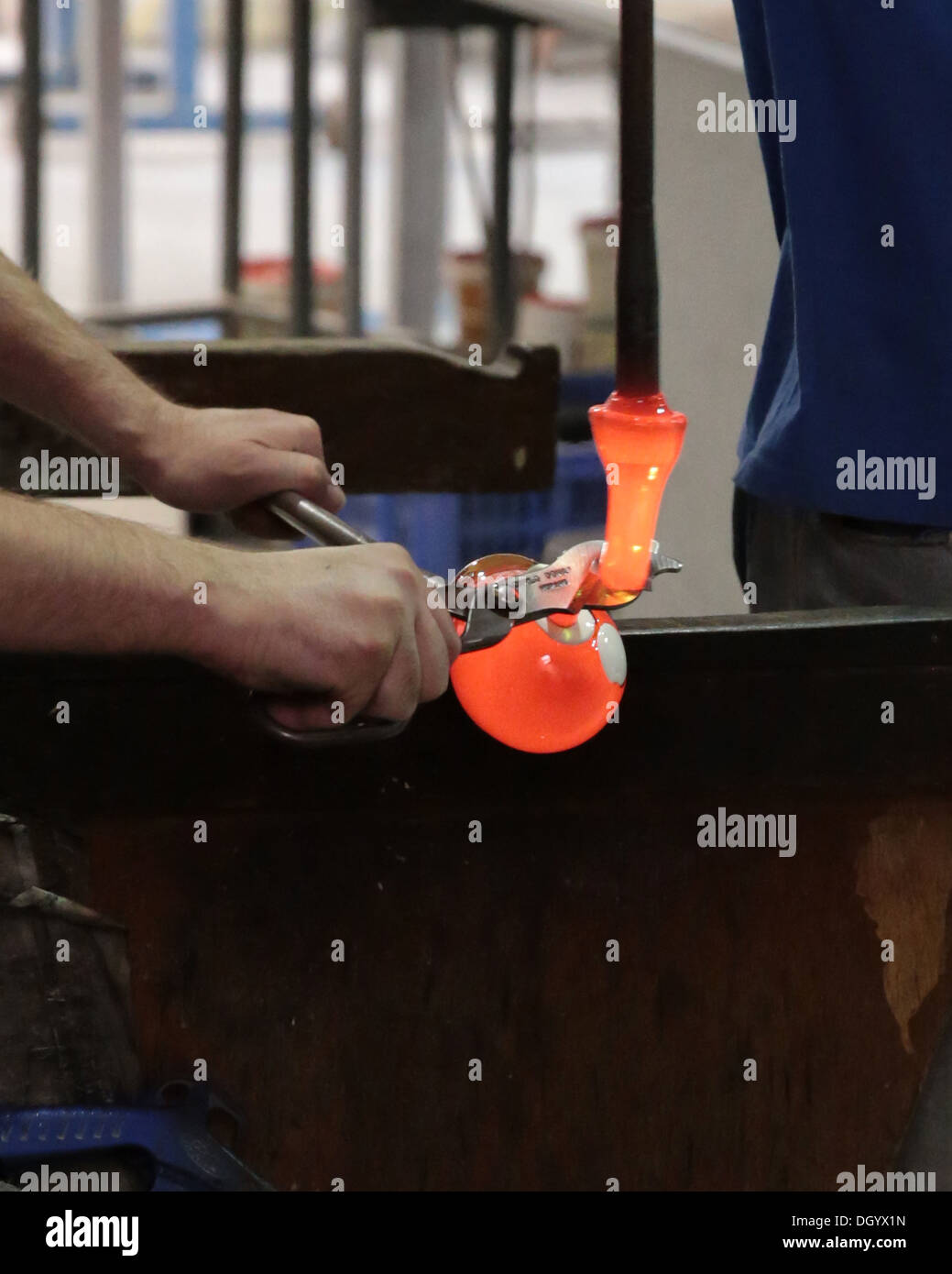 Making glass paperweights using diamond shears to add a piece of molten glass to the workpiece