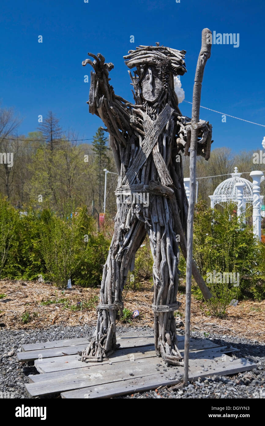 An unusual man like statue made of tree branches in the Fairy garden at the 'Route des Gerbes d'Angelica' garden in Mirabel, Stock Photo